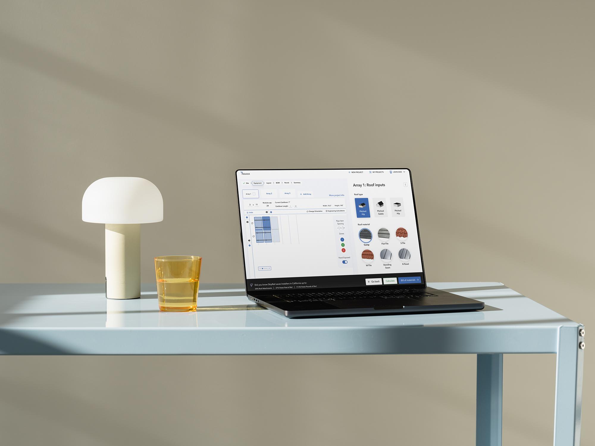Pegasus Solar design tool open on a laptop, showing roof and equipment inputs